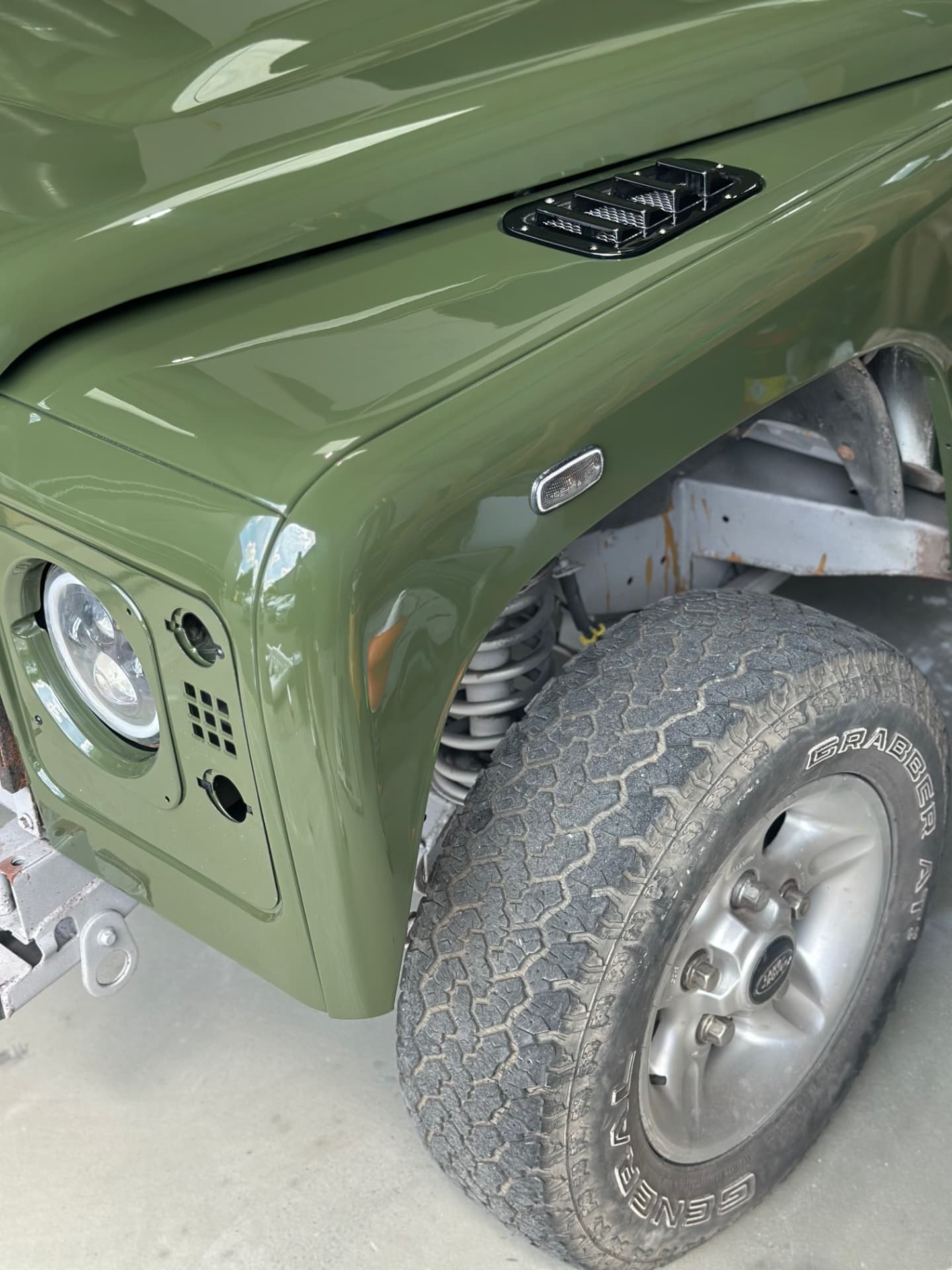 Freshly painted green Land Rover Defender wing detail