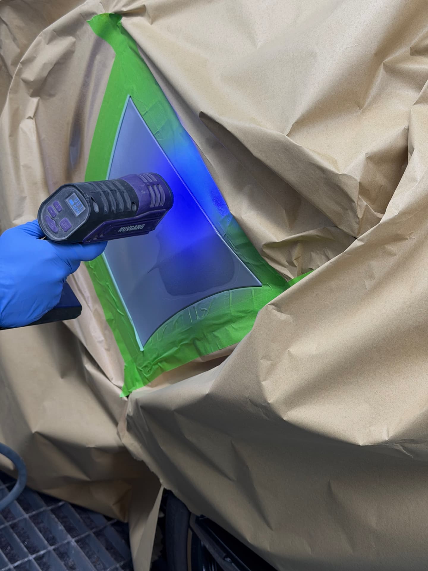 UV curing lamp hardening fresh paint on a masked panel