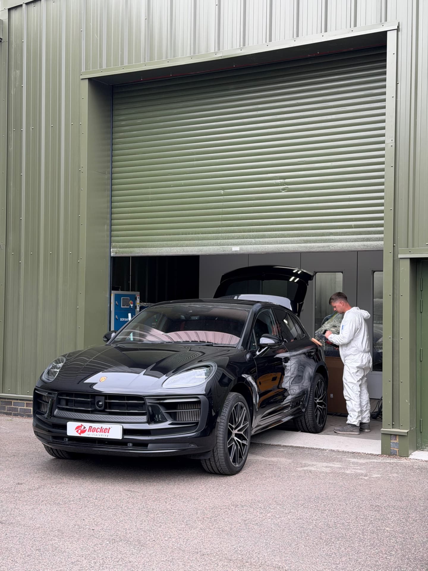 Porsche Macan being worked on at the workshop door